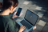 Woman logging into her laptop, using her phone for authentication 