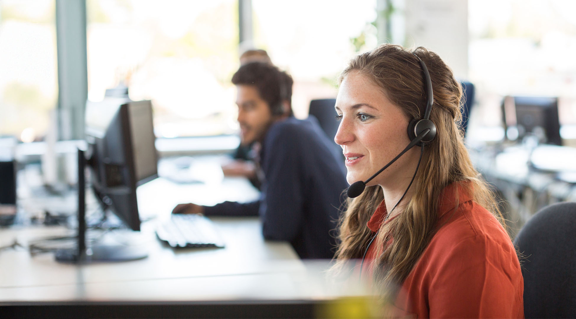 Woman in an office talking on a headset