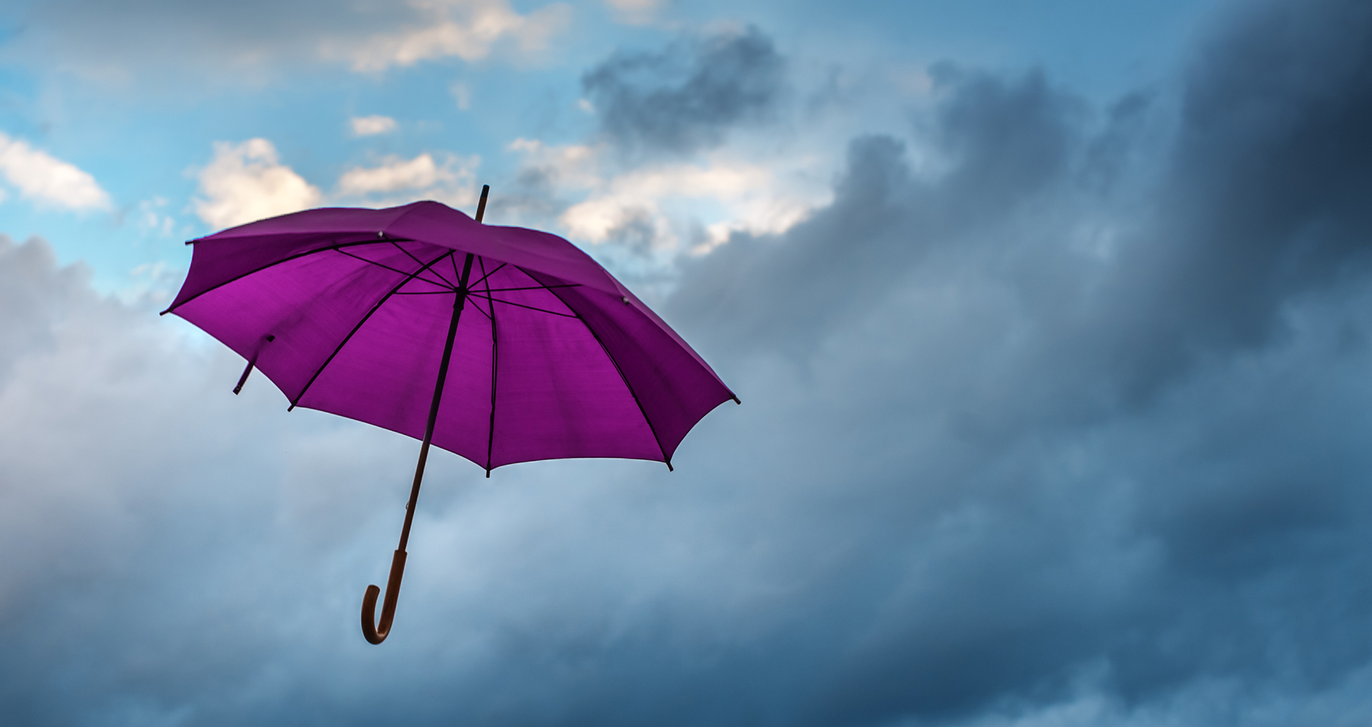 Purple umbrella on a rainy day, symbolising AIB insurance covering you in your time of need.