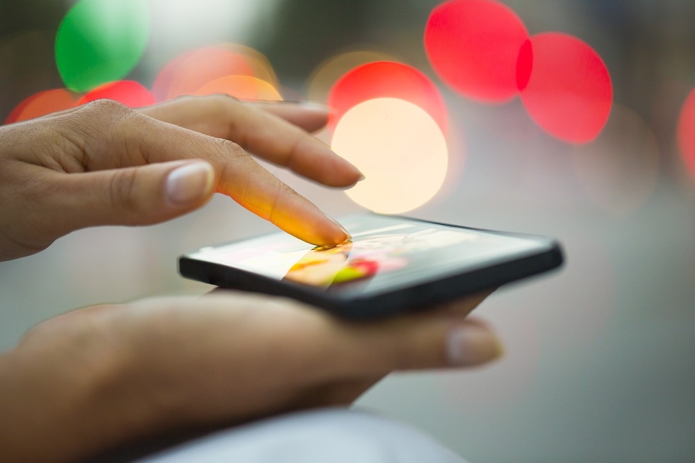 Woman using her phone to calculate her mortgage.