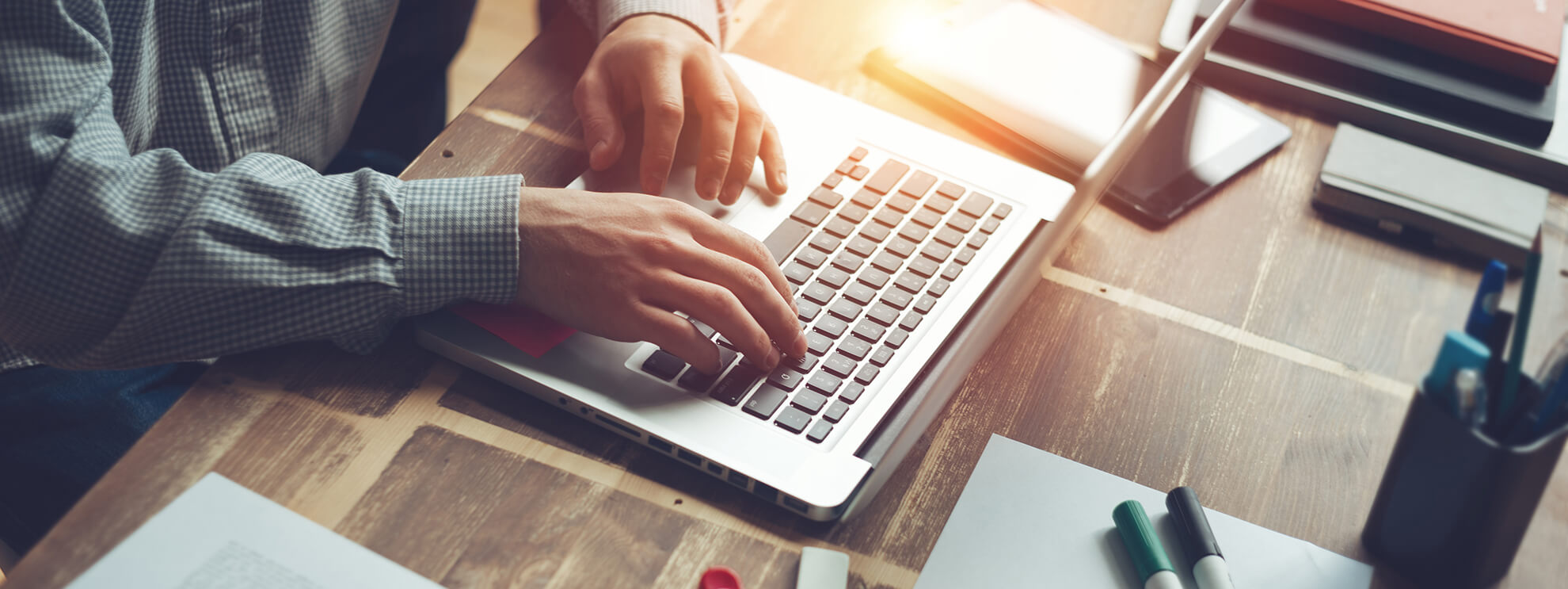 man typing on laptop