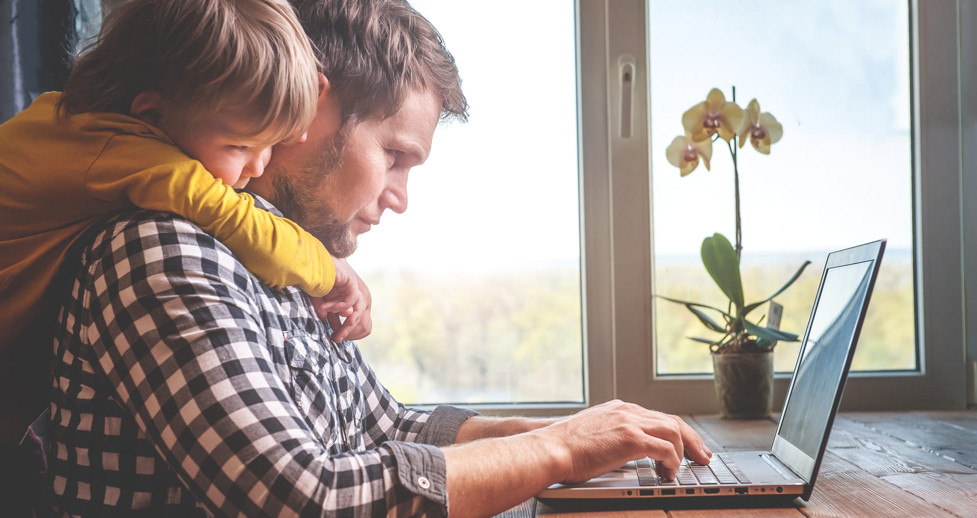 man and son looking at a laptop