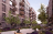 Apartment blocks facing each other with trees lining the centre walkway