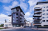 Grey apartment building beside white apartment bulding