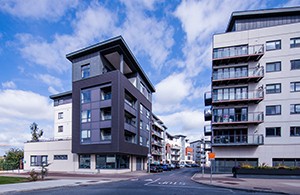 Grey apartment building beside white apartment bulding