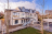 Apartment building with grass and trees in forground