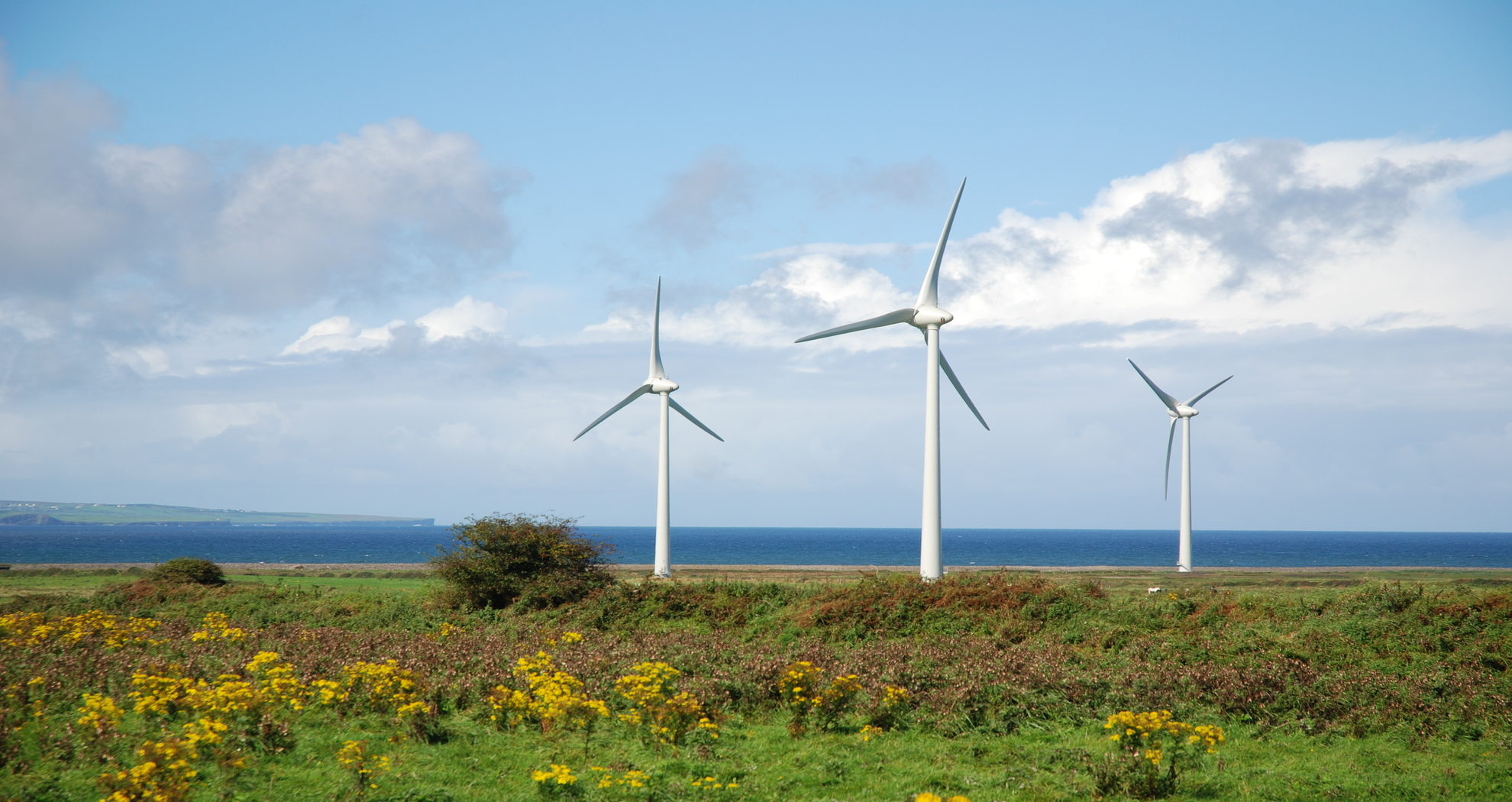 View of wind turbines with the sea in the background