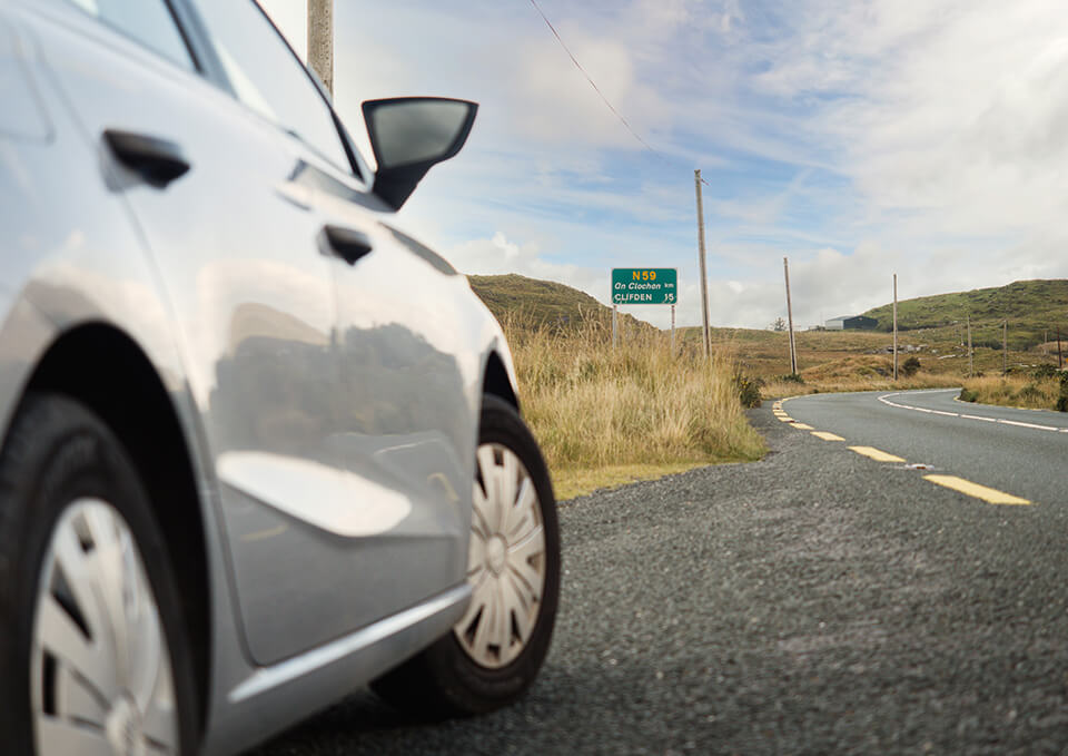 A close up, side view of a car parked on the side of the road.