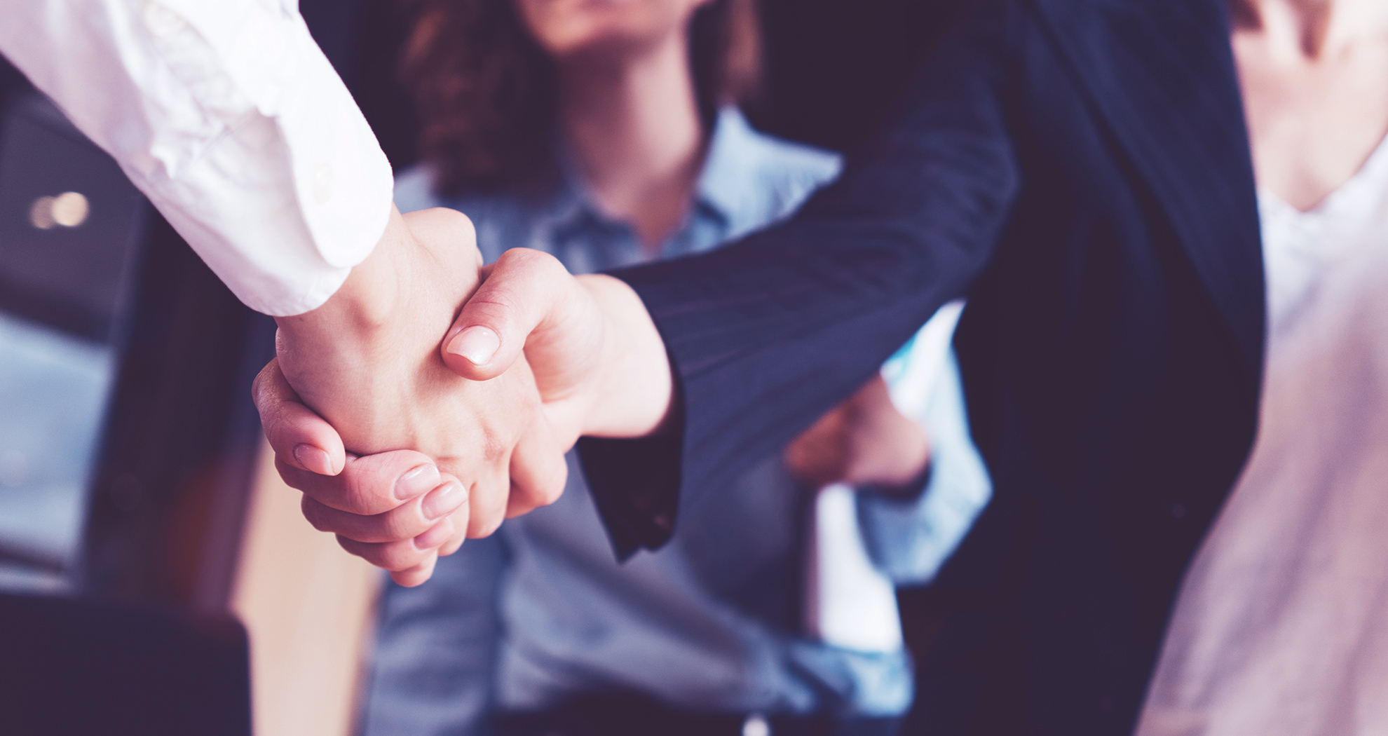 Close up of a man and woman shaking hands.