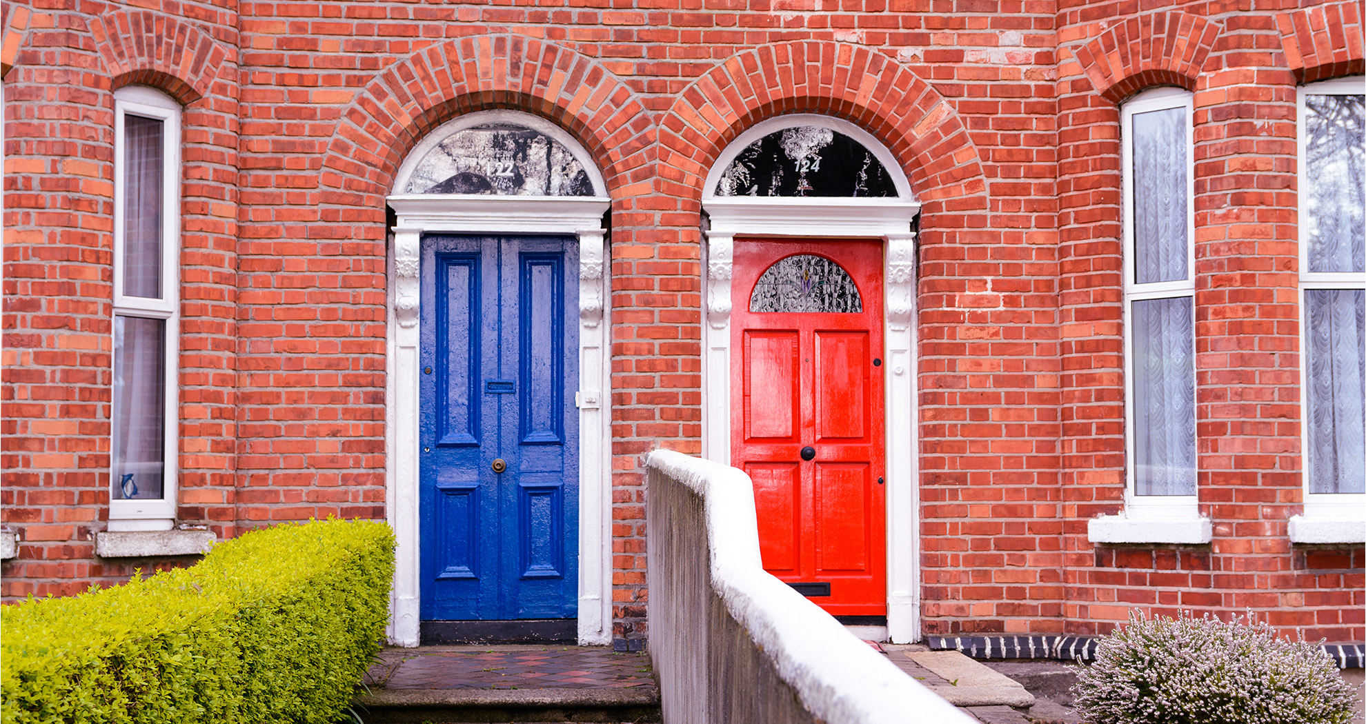 Close up of the front of two attached houses.