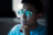 Man looking thoughtfully with computer screen reflected in his glasses.