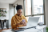 Woman on her phone at home reporting fraud.